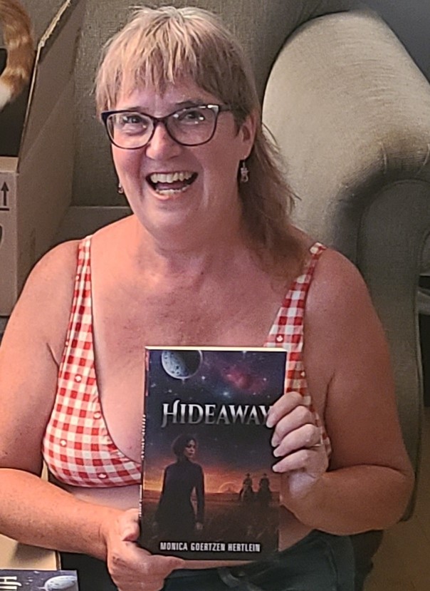 Monica holding a copy of Hideaway.